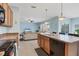 Open kitchen with wood cabinets flows into a bright living area, perfect for Gathering time and entertaining at 15081 Aldama Cir, Port Charlotte, FL 33981