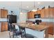 Well-equipped kitchen with wooden cabinets, a kitchen island and modern appliances at 15081 Aldama Cir, Port Charlotte, FL 33981
