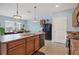 Open-concept kitchen featuring wood cabinets, black appliances, and a bright, airy atmosphere, perfect for cooking at 15081 Aldama Cir, Port Charlotte, FL 33981