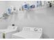 Clean laundry room featuring a washer, dryer, and shelving for storage at 15081 Aldama Cir, Port Charlotte, FL 33981