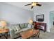 Relaxing living area with soft green sofa, computer desk, and warm lamps, perfect for relaxing and working at 15081 Aldama Cir, Port Charlotte, FL 33981