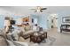 Open-concept living room and kitchen with tile floors and comfortable seating at 15081 Aldama Cir, Port Charlotte, FL 33981
