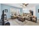 Bright living room featuring neutral furniture and large windows providing ample natural light at 15081 Aldama Cir, Port Charlotte, FL 33981
