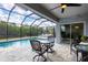 Screened-in pool area with a pool and outdoor seating for a relaxing backyard oasis at 15081 Aldama Cir, Port Charlotte, FL 33981
