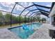 Screened-in pool area with a pool and outdoor seating for a relaxing backyard oasis at 15081 Aldama Cir, Port Charlotte, FL 33981