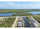 Scenic aerial view of a waterfront community, featuring beautiful canals, lush greenery, and stunning ocean views at 15610 Seafoam Cir, Port Charlotte, FL 33981