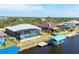 Aerial view of the home, screened lanai, boat dock, and waterfront at 15610 Seafoam Cir, Port Charlotte, FL 33981