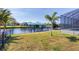 Landscaped backyard with a view of the canal and private boat dock at 15610 Seafoam Cir, Port Charlotte, FL 33981
