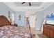 Spacious bedroom with decorative crown molding, a ceiling fan, and an ensuite bathroom at 15610 Seafoam Cir, Port Charlotte, FL 33981