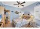 Nautical-themed bedroom featuring a ceiling fan, decorative wall art, and a window with plantation shutters at 15610 Seafoam Cir, Port Charlotte, FL 33981