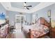 Primary bedroom featuring a tray ceiling, a ceiling fan, and plenty of natural light at 15610 Seafoam Cir, Port Charlotte, FL 33981