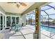 Screened-in lanai features a dining table and chairs with a pool and waterfront view at 15610 Seafoam Cir, Port Charlotte, FL 33981