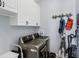 Laundry room equipped with a stainless steel washer and dryer, plus ample cabinet space at 15610 Seafoam Cir, Port Charlotte, FL 33981