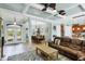 Inviting open-concept living space with tile floors, coffered ceilings, and views of the entryway and dining area at 15610 Seafoam Cir, Port Charlotte, FL 33981