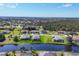 Community aerial view showcasing several homes along a waterway and lush landscape at 170 Long Meadow Ln, Rotonda West, FL 33947