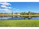 Backyard with a picturesque water view of the lake, complementing the lush landscaping and waterfront homes at 170 Long Meadow Ln, Rotonda West, FL 33947