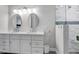 Bright bathroom with a double sink vanity, quartz countertops, and a glass enclosed shower with tiled walls at 170 Long Meadow Ln, Rotonda West, FL 33947