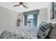 Comfortable bedroom featuring a ceiling fan, bright window, and a bed with a patterned blue quilt at 170 Long Meadow Ln, Rotonda West, FL 33947