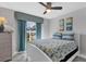 Cozy bedroom featuring a ceiling fan, bright window, beach-themed decor and a bed with a white frame at 170 Long Meadow Ln, Rotonda West, FL 33947
