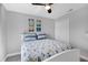 Comfortable bedroom featuring a ceiling fan, double closet, and a bed with patterned blue quilt at 170 Long Meadow Ln, Rotonda West, FL 33947