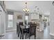 Dining room with seating for six and adjacent kitchen area at 170 Long Meadow Ln, Rotonda West, FL 33947