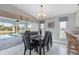 Dining room with modern chandelier and view of the screened-in pool area at 170 Long Meadow Ln, Rotonda West, FL 33947