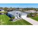 Beautiful aerial view of home with lush landscaping, well-manicured lawn, and large driveway at 170 Long Meadow Ln, Rotonda West, FL 33947