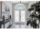 Bright foyer with tiled floor, decorative console table, and palm tree accent at 170 Long Meadow Ln, Rotonda West, FL 33947