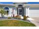Inviting home exterior with a landscaped garden and walkway to the entrance at 170 Long Meadow Ln, Rotonda West, FL 33947