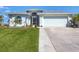 Charming single-story home with well-manicured lawn and two-car garage at 170 Long Meadow Ln, Rotonda West, FL 33947