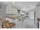 Open concept kitchen with breakfast bar, granite counters, white cabinets, and stainless steel appliances at 170 Long Meadow Ln, Rotonda West, FL 33947