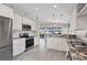 Bright kitchen with granite countertops, stainless steel appliances, and white cabinets at 170 Long Meadow Ln, Rotonda West, FL 33947