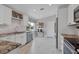 Bright kitchen with white cabinets, stainless steel appliances, and granite counters at 170 Long Meadow Ln, Rotonda West, FL 33947