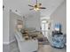 Comfortable living area with stylish decor, ceiling fan, and tiled flooring at 170 Long Meadow Ln, Rotonda West, FL 33947