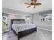 Cozy main bedroom with large bed and tropical-themed ceiling fan at 170 Long Meadow Ln, Rotonda West, FL 33947