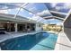 Pool and covered patio, ideal for outdoor living and entertaining, with seamless indoor-outdoor flow and beautiful water views at 170 Long Meadow Ln, Rotonda West, FL 33947