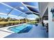 Sparkling pool enclosed by a screened lanai, offering a tranquil retreat with beautiful water views in the backyard at 170 Long Meadow Ln, Rotonda West, FL 33947