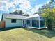 A beautiful backyard with a pool, screened-in lanai, and large grassy area at 18198 Griffen Ave, Port Charlotte, FL 33948