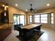 Bright game room with a pool table, tiled floor, and natural light from a large bay window at 18198 Griffen Ave, Port Charlotte, FL 33948