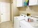 Laundry room with a washer and dryer with cabinets at 18198 Griffen Ave, Port Charlotte, FL 33948