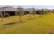 The backyard features lush grass with manicured landscaping at 18575 Midsummer Pl, Venice, FL 34293