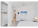 Bedroom featuring a beach-scene TV display, closet, and a comfortable bed at 18575 Midsummer Pl, Venice, FL 34293