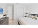 Bedroom features a TV, closet, dresser and a modern ceiling light at 18575 Midsummer Pl, Venice, FL 34293
