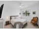 Bright bedroom with a large window, ceiling fan and classic furniture at 18575 Midsummer Pl, Venice, FL 34293