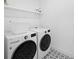 This laundry room features an LG washer and dryer set with patterned tile flooring at 18575 Midsummer Pl, Venice, FL 34293