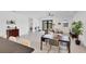 Spacious living area with a dining table, sliding doors to the backyard, and modern decor, offering a comfortable and inviting atmosphere at 18575 Midsummer Pl, Venice, FL 34293