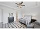 This main bedroom offers style and comfort with its star-patterned floor and a ceiling fan at 18575 Midsummer Pl, Venice, FL 34293