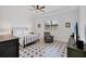A spacious main bedroom featuring a stylish star-patterned floor and a ceiling fan at 18575 Midsummer Pl, Venice, FL 34293
