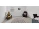 A cozy room featuring a neutral carpet, a window, and two chairs for relaxing at 18575 Midsummer Pl, Venice, FL 34293
