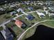 Aerial view of a residential neighborhood with mature trees, showcasing roof types and pool areas at 19 Windward Rd, Placida, FL 33946